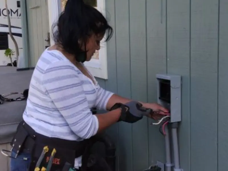 Licensed electrician wiring an exterior subpanel in Summit Park